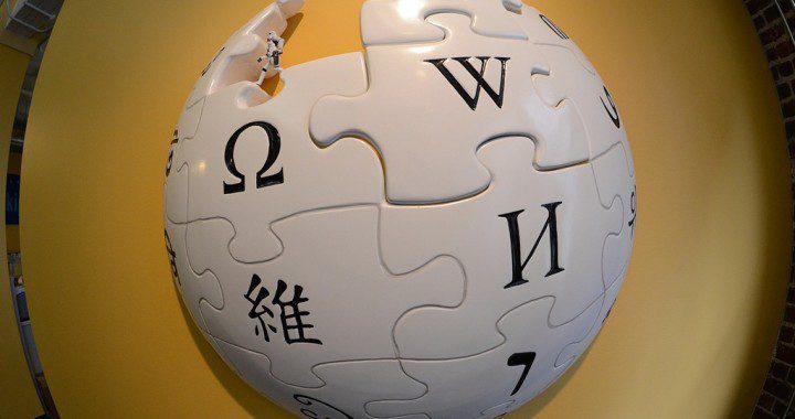 Wikipedia Logo on Yellow Wall